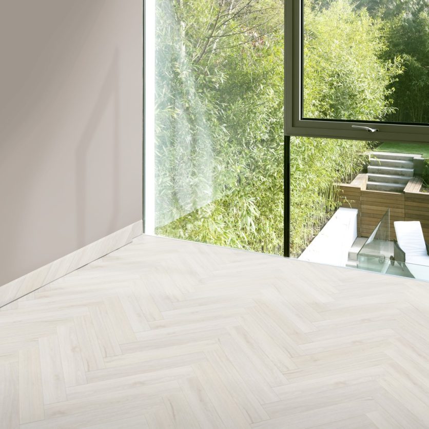 Pro-Tek™ Editions Herringbone Syon White Luxury Vinyl Click Flooring Installed in a Hallway