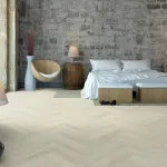 Pro-Tek™ Editions Herringbone Hampton Grey Luxury Vinyl Click Flooring Installed ina Bedroom