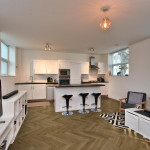 Pro-Tek™ Editions Herringbone Harewood Oak Luxury Vinyl Click Flooring Installed in a Sophistacated Kitchen