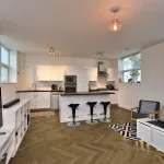 Pro-Tek™ Editions Herringbone Harewood Oak Luxury Vinyl Click Flooring Installed in a Sophistacated Kitchen